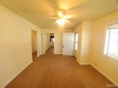 Unfurnished bedroom with carpet flooring and ceiling fan