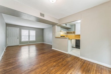 Unfurnished living room featuring hardwood / wood
