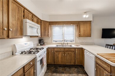 Kitchen has double stainless steel sink and gas co