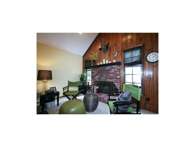 Brick fireplace and vaulted ceiling in great room