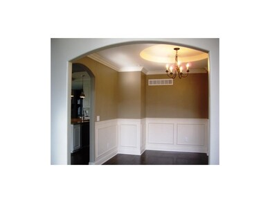Dining room has wainscoating detail and recessed a