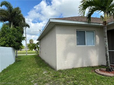 View of side of home featuring a yard