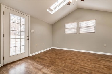 Empty room featuring a ceiling fan, plenty of natu