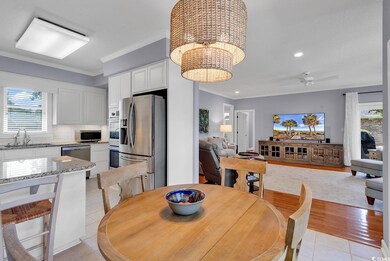 Tiled dining space with sink, ceiling fan with not