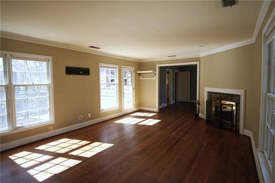 Unfurnished living room with crown molding, a fire