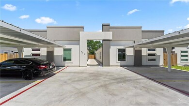 View of front of property featuring covered parking and stucco siding