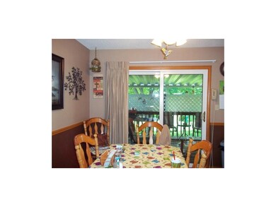 Dining area looks out to covered deck.  Newer viny
