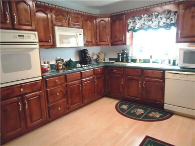 The kitchen is a cook's dream with custom cabinetry,built -in oven, cooktop, microwave and dishwasher. Room for two cooks with lots of work space including an island and desk area. 
