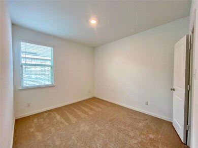 Unfurnished room featuring light carpet