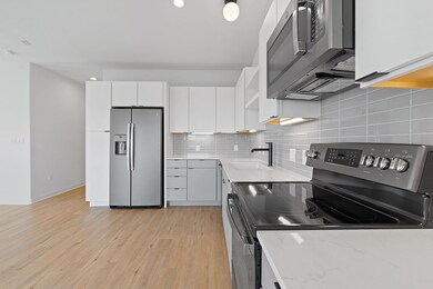Kitchen featuring tasteful backsplash, light wood
