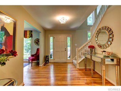 Foyer with hardwood floors and open to the dining 