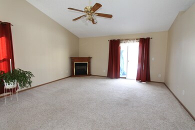 Great Room with Cathedral Ceiling, plant ledges, ceiling fan, fireplace and patio doors to deck!
