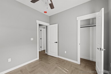 Unfurnished bedroom featuring baseboards, a closet