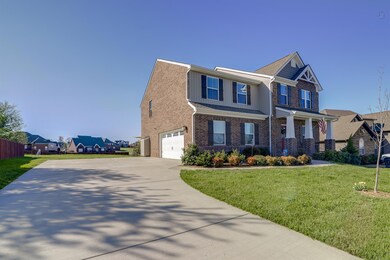 Large driveway with attached 2 car garage.