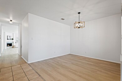 Unfurnished room with a tiled fireplace, a notable