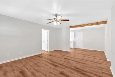 Family room looking into breakfast room, back door and primary suite