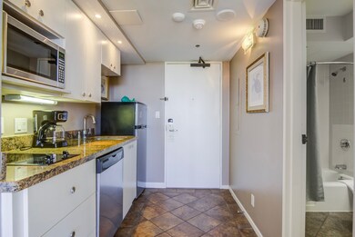 Entrance to the condo with the kitchenette to the