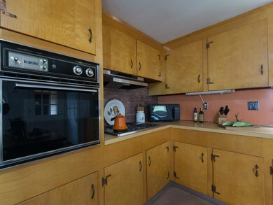 The kitchen features a brick...