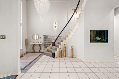 Entryway featuring stairway, light tile patterned 