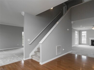 Stairs leading two the six bedrooms, 3 full baths upstairs on the second floor and then a third floor with bonus room!  This photo shows off the openness of this home.