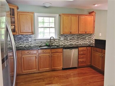 Great kitchen with granite and back splash that ov
