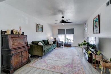 Living room with baseboards, visible vents, light 