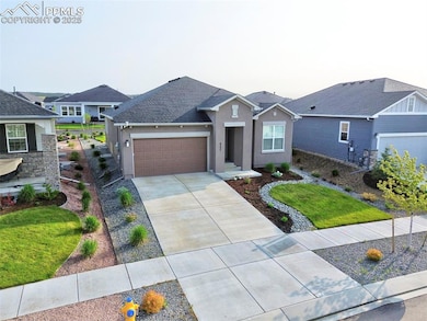 Ranch-style house featuring stucco siding, an attached garage, concrete driveway, and a front lawn
