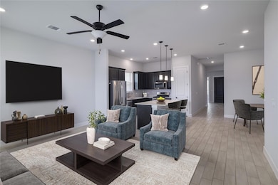 Living room with a ceiling fan, recessed lighting