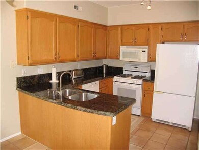 Remodeled kitchen with granite slab countertops, u