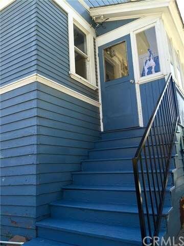 Rear Entrance with Wrought Iron Railing.