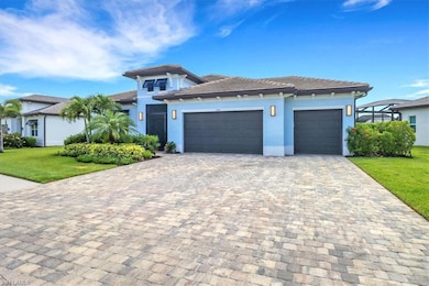 View of front of property featuring an attached garage, decorative driveway, a front lawn, stucco siding, and a tiled roof