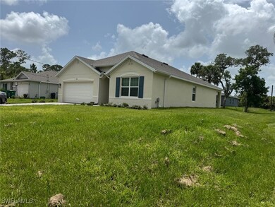 View of front of property with a garage, stucco si