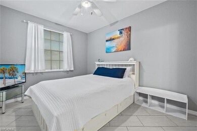 Bedroom featuring baseboards, a ceiling fan, and light tile patterned flooring