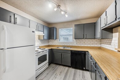 Kitchen with white appliances, under cabinet rang