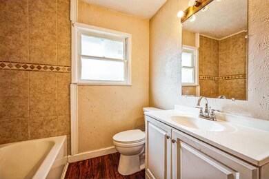Full bathroom with toilet, plenty of natural light