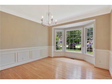 Formal dining room with wood floor, transom window