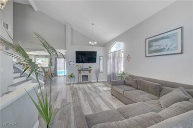 Living area with a chandelier, wood finished floor