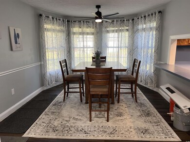 Dining room featuring dark wood-type flooring, a t
