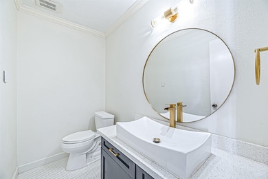 A compact and stylish half bath located on the mai