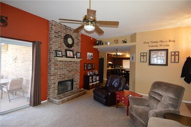 Living room with ceiling fan and patio door