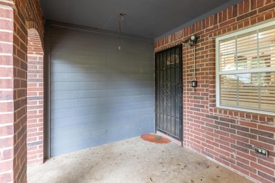 View of exterior entry with brick siding