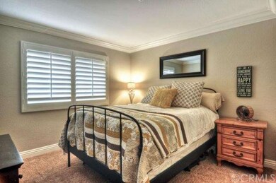 Secondary room with custom plantation shutters, crown molding, and 7.5 inch baseboards ~
