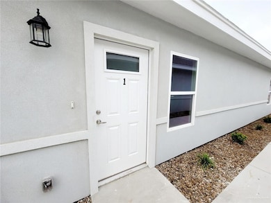 Entrance to property featuring stucco siding