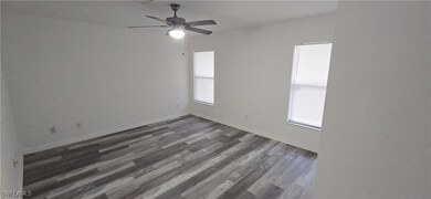 Spare room featuring plenty of natural light, dark