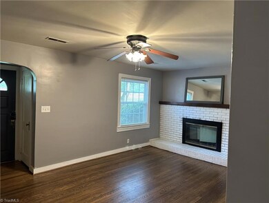 Living room with fireplace view from hallway