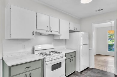 Bright and open kitchen with new gas stove and hoo