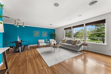 Living room with wood finished floors and ornamen