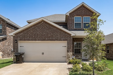 View of front of home featuring roof with shingles, a garage, brick siding, and concrete driveway