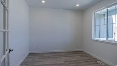 Empty room featuring light wood-type flooring and recessed lighting