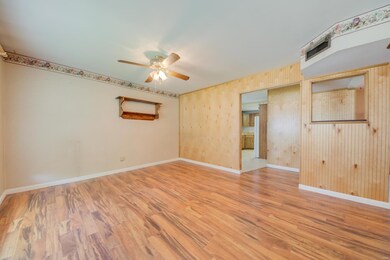 Laminate flooring in living room with ceiling fan 